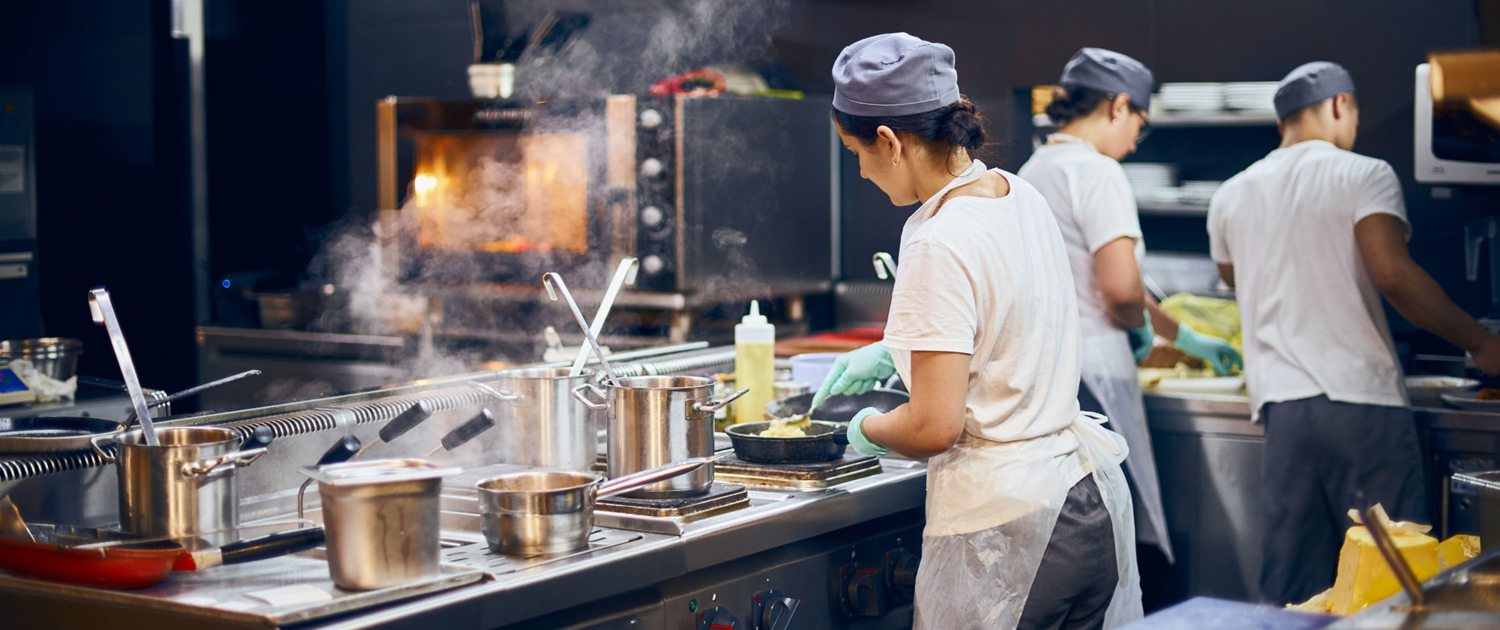 Cooks Working In Restaurant Kitchen